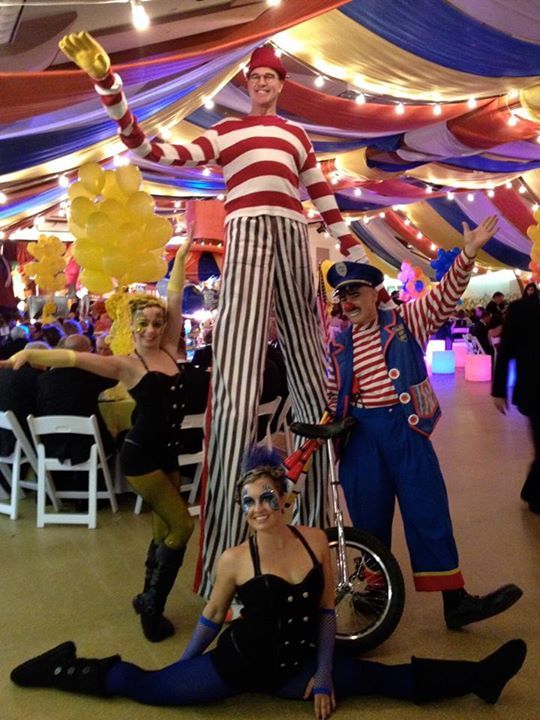 John Hadfield on stilts with the unicyclist and the contortionists